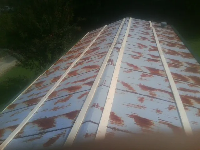 Rusted metal roof panels with new wood purlins before replacement — Storm Damage Roof Repair in Estillfork by Roofing Brothers